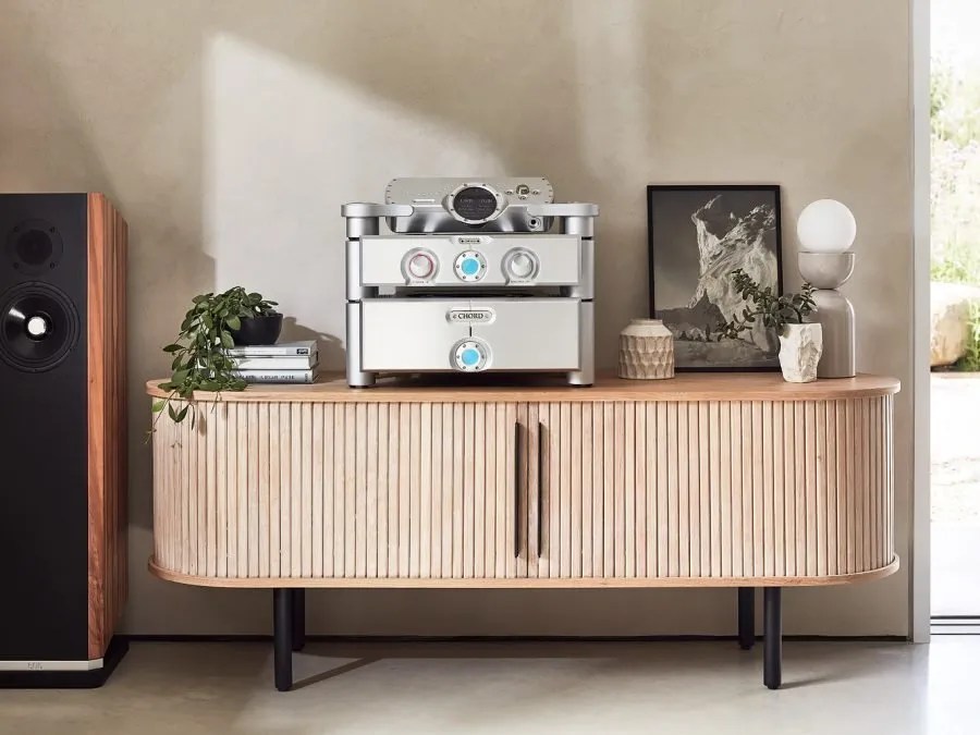 A three-box silver Choral system on Ensemble stands with DAVE on top, on an oak sideboard beside a floorstanding loudspeaker