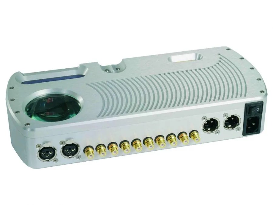 Rear three-quarter of the silver Prima: two balanced XLR inputs, ten unbalanced RCA connections, two XLR outputs, mains switch and IEC inlet, with the porthole and the ribbed top panel above