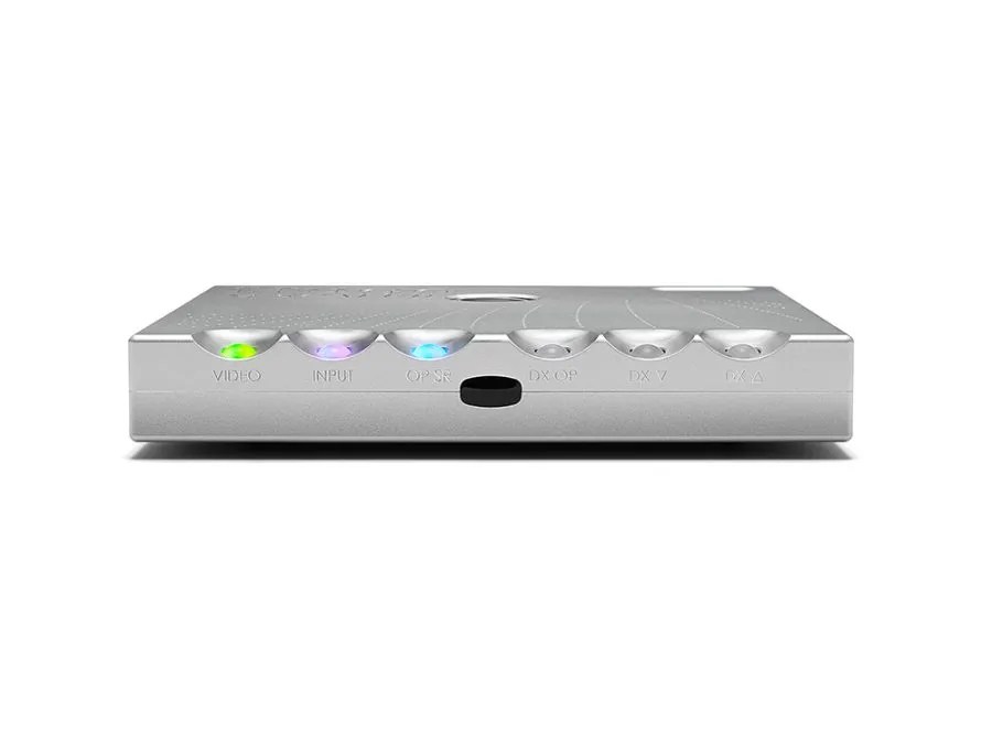Front of the silver Hugo M Scaler: the six control spheres labelled VIDEO, INPUT, OP SR, DX OP, DX V and DX A, the first three lit green, lilac and blue, with the infrared window between them
