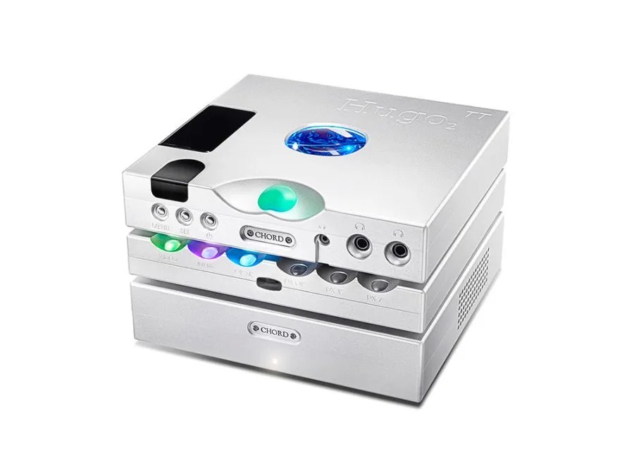 The three-box Table Top system in silver: Hugo TT 2 on top with its blue porthole and green volume sphere, the Hugo M Scaler in the middle, and a matching Chord power amplifier at the foot