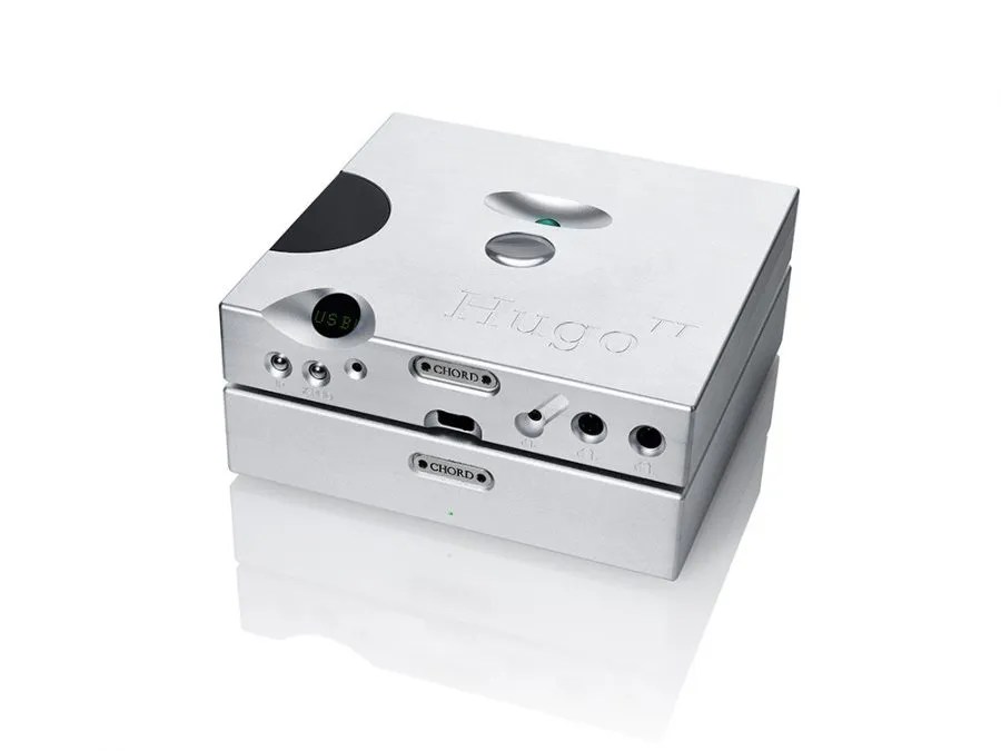 The two-box desktop system in silver: a Hugo TT sitting on the TToby, the two boxes sharing one footprint, the CHORD badge and green indicator on the amplifier below