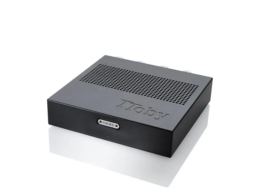 The TToby in the black finish, three-quarter view: the perforated vent panel across the lid, the engraved TToby name, the milled CHORD badge on the fascia and the green power indicator