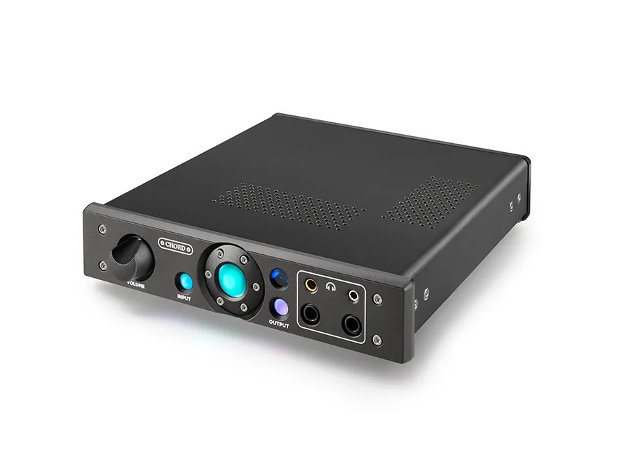 The black Alto in three-quarter view: the perforated vents across the lid, the milled front panel with its VOLUME knob, the turquoise-lit sphere and the four headphone sockets